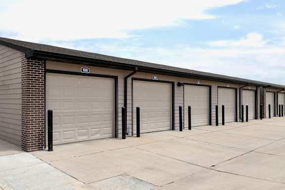 A long row of garage doors are closed.