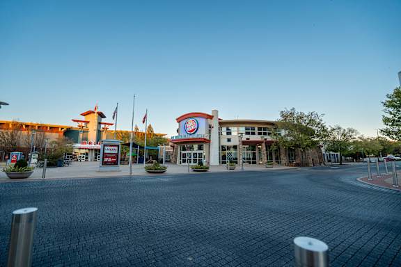 Located by nearby shops and dining at The Grove in Rogers, AR