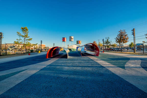 A colorful sculpture in the middle of a road.
