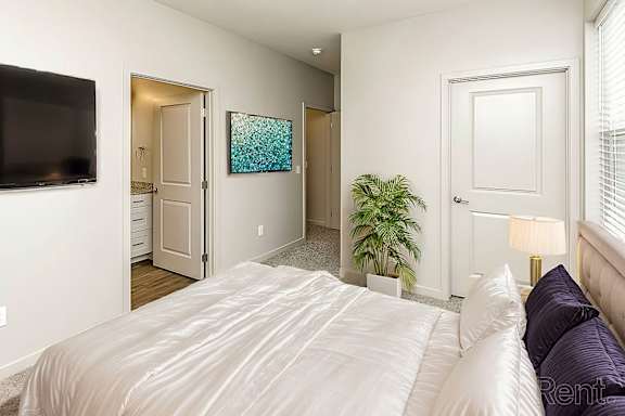 Bedroom With wall mounted TV at Sandstone Villas Apartments, Omaha, NE 68116