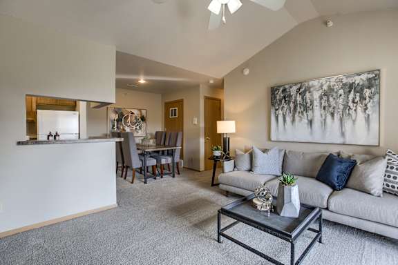 A living room with a grey couch and a coffee table.