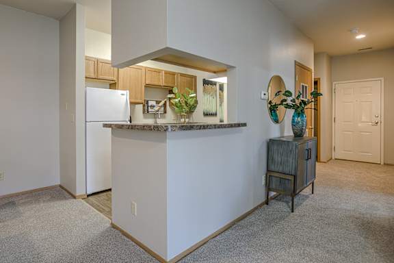 A kitchen island with a refrigerator and a plant on it.