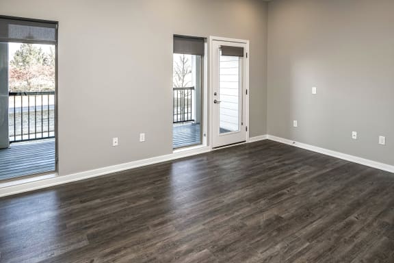 Living room with wood style plank flooring at Vue 178 in Omaha, NE
