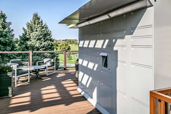 A patio with a table and chairs is on a deck at Tiburon View Apartments, Omaha 68136