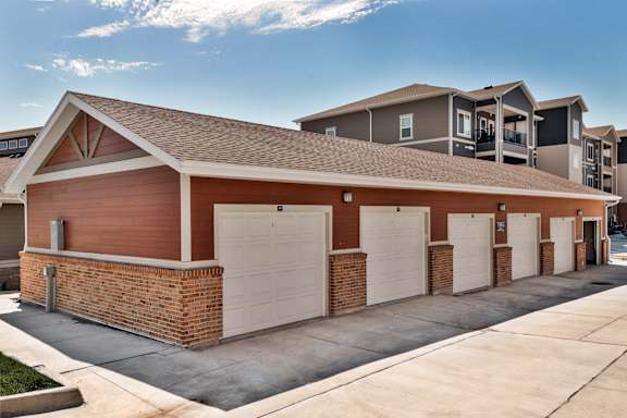 A row of garage doors in front of a building.