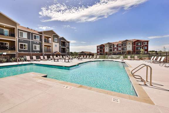 A swimming pool surrounded by apartment buildings.