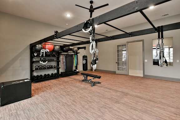A gym with a pull up bar and weights.