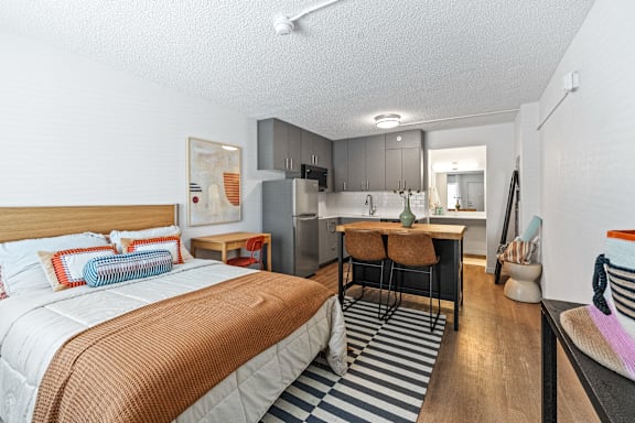 A bedroom with a bed, desk, and chair.at The Teale Siesta Lago in Kissimmee, FL, 34746