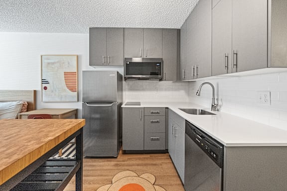 A kitchen with a refrigerator, microwave, and dishwasher.at The Teale Siesta Lago in Kissimmee, FL, 34746