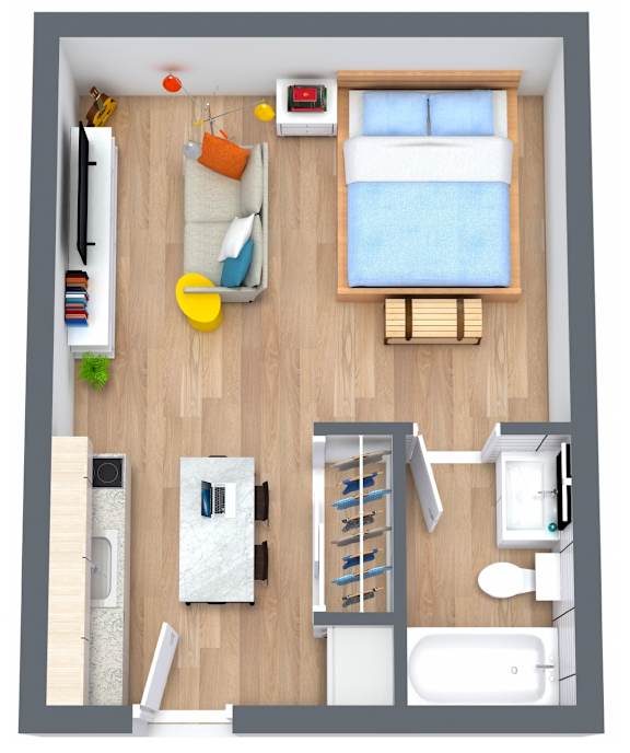 A top-down view of a small apartment with a bed, a desk, a chair, a couch, a kitchenette, and a bathroom at The Teale Golden Gate in Naples, FL, 34116