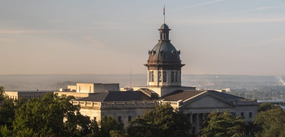 A large building with a tower is surrounded by trees. at The Lady, South Carolina