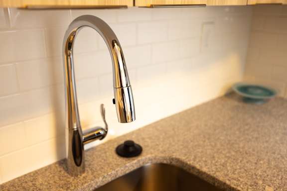 a kitchen sink with a chrome faucet on a granite counter top at The Teale, Kissimmee, FL, 34746