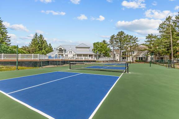 A tennis court with a blue surface and white lines.