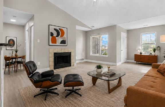 A living room with a fireplace and a painting on the wall.