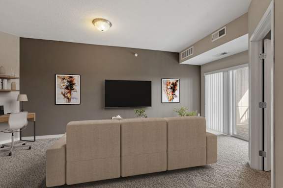 A living room with a couch, a television, and a chair.