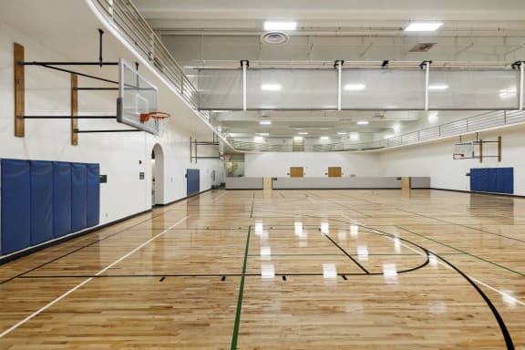 a basketball court in a gym with a wood floor