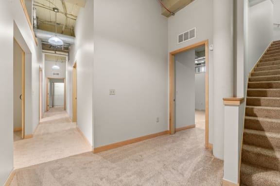 Lower level hallway and staircase. Lowertown Lofts  in St. Paul, MN 3 Bedroom 2.5 Bath Plus Den Apartment  at Lowertown Lofts, Minnesota