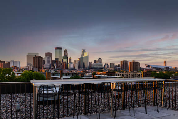 Rooftop Deck with Grills and Fire Pits and a view of the Skyline at The Whit, Minneapolis
