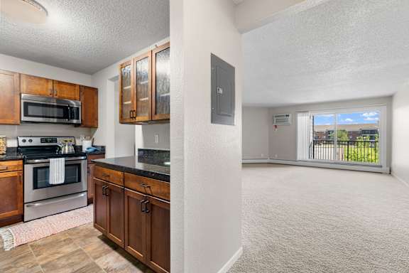 Kitchen and living room in the Mahogany floor plan at Cedars Lakeside, Little Canada 55117