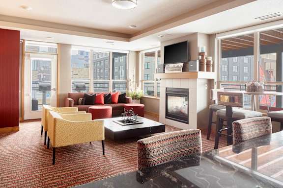 Living room with a fireplace and a television at The Palmer, Minneapolis, MN, Minnesota, 55401