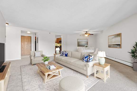 Living room and dining room in the Mahogany floor plan at Cedars Lakeside, Little Canada 55117