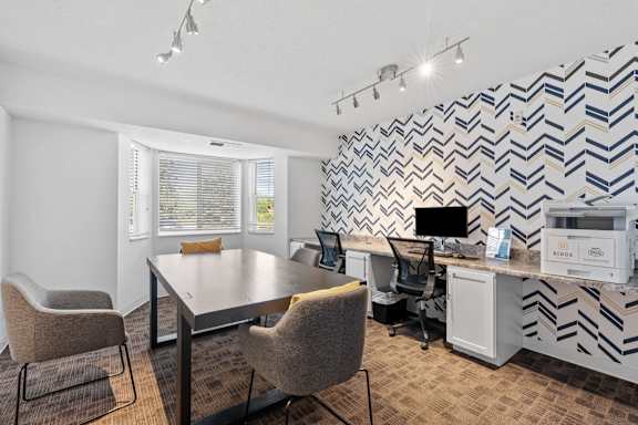A conference room with a chevron patterned wall.