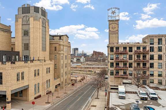 A city street with a clock tower in the background.
