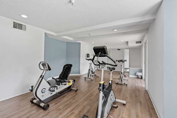 A room with a row of exercise bikes.