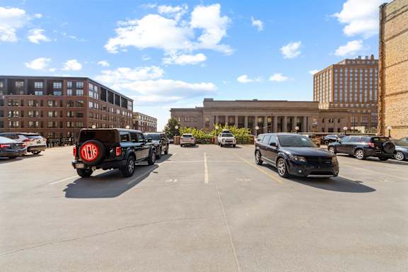 A parking lot with cars and buildings in the background.