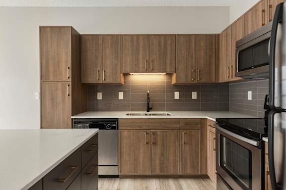 A kitchen with wooden cabinets and stainless steel appliances.