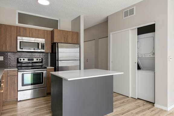 A kitchen with a stove, oven, and refrigerator.
