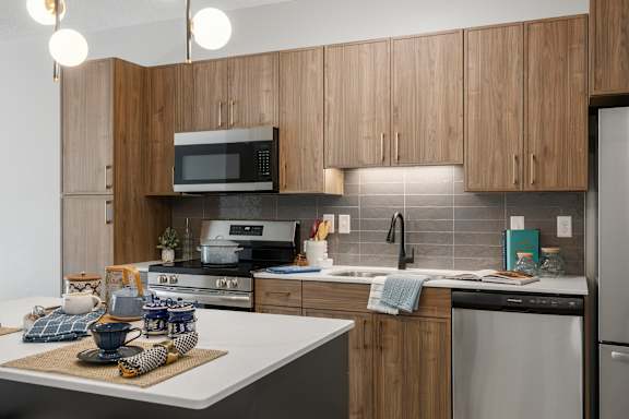 A kitchen with wooden cabinets and a white countertop.