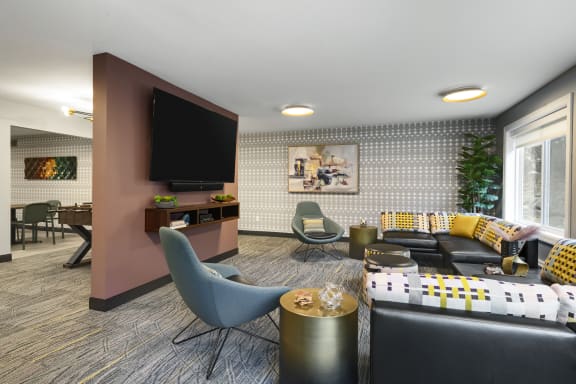a living room filled with furniture and a television  at Cedars Lakeside, Little Canada, Minnesota