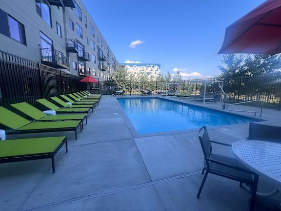 A pool area with sun loungers and a table.