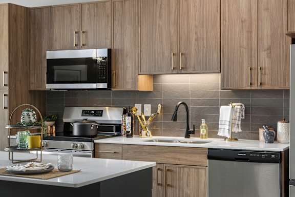 The Ellory Kitchen - A modern kitchen with a stainless steel oven and a microwave above it.