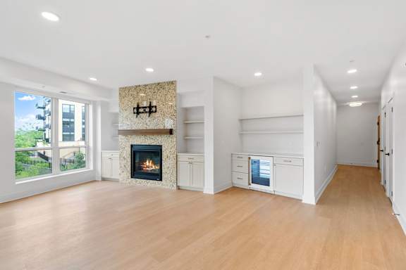 Lilia Apartments Marble Fireplace with tv mount and beverage refrigerator