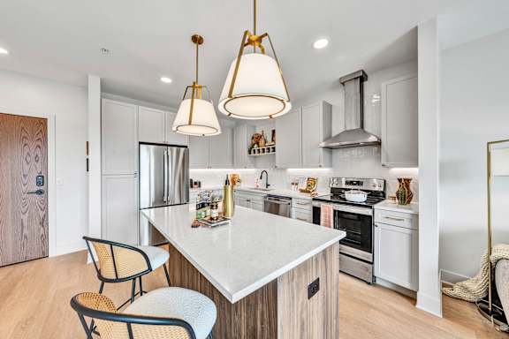 A modern kitchen with a white countertop and a large island.
