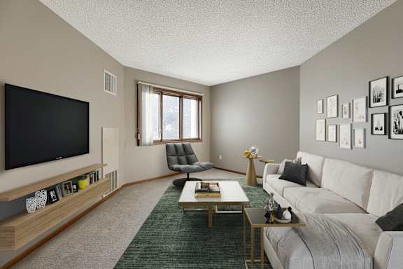 A living room with a white couch and a television.