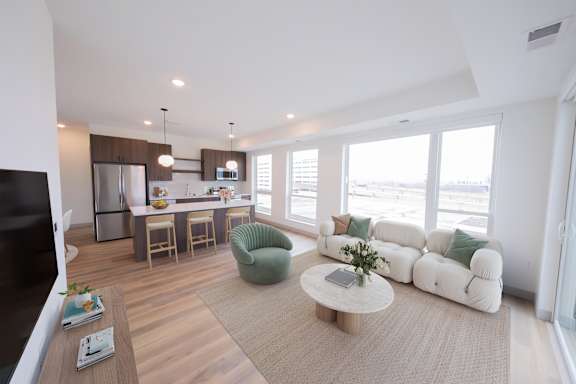 Living, dining, and kitchen areas in the C4 two bedroom two bathroom floor plan at The Mera in St. Louis Park, Minnesota