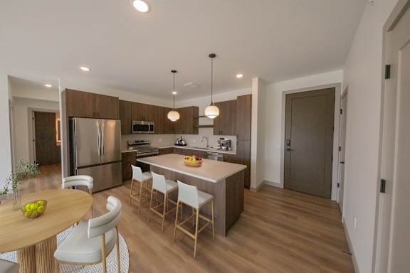 Kitchen and dining area in the CC3 two bedroom plus den, two bathroom floor plan at The Mera in St. Louis Park, Minnesota