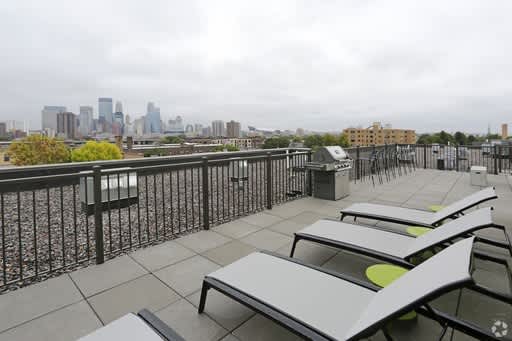 Rooftop Deck with Grills and Fire Pits and a view of the Skyline at The Whit, Minneapolis
