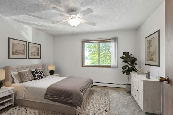 A bedroom with a bed, dresser, and ceiling fan.