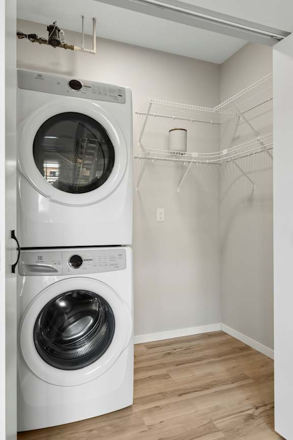The Ellory - A white dryer and washer in a laundry room.