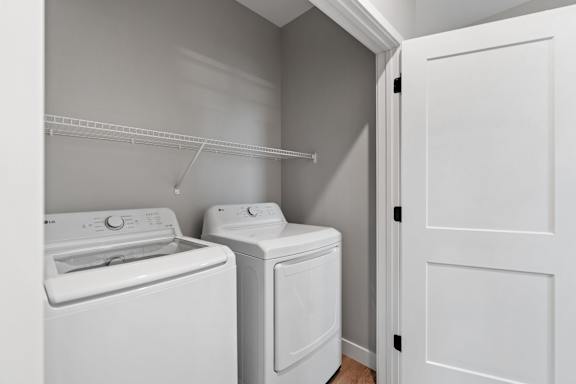 A white washing machine and dryer in a laundry room.