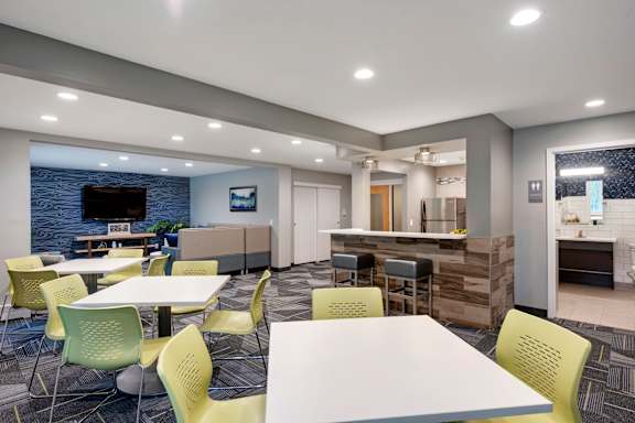 A modern dining area with a bar and a television.