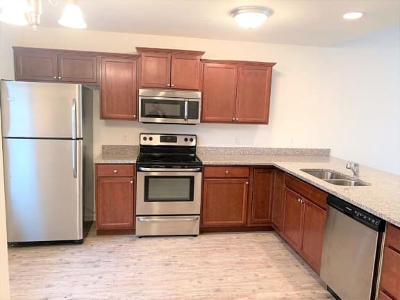 Kitchen with wooden cabinets and appliances at Hawthorne Properties, Lafayette, 47905