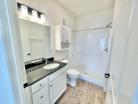 A bathroom with a sink, toilet, and shower.at Concord Crossing, Lafayette, IN 47909