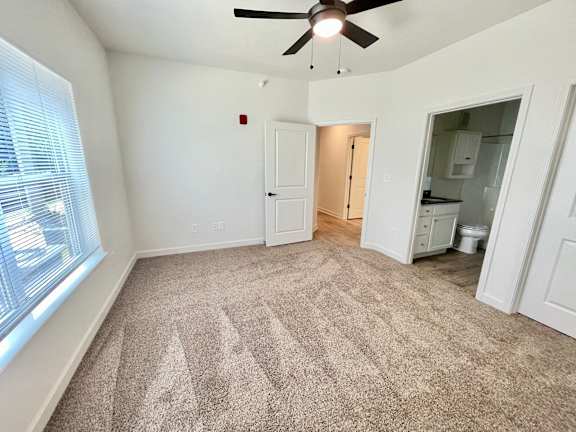 A room with a carpeted floor and a ceiling fan.at Concord Crossing, Lafayette, IN 47909