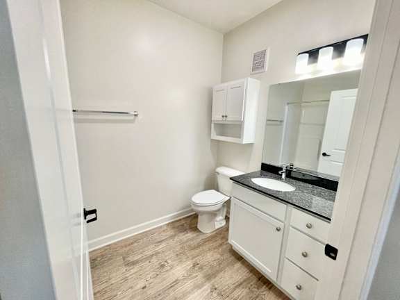 A bathroom with a toilet, sink, and medicine cabinet.at Concord Crossing, Lafayette, IN