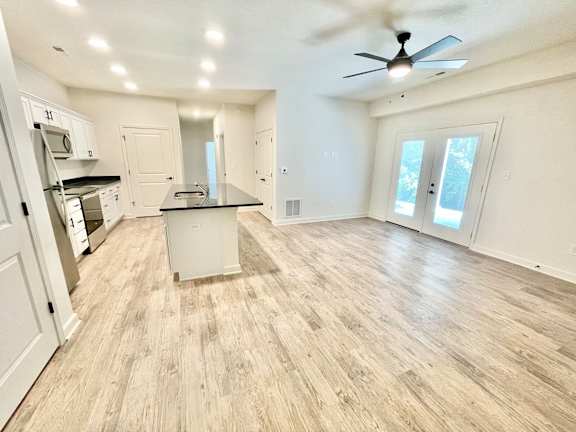 A spacious kitchen with a ceiling fan and lighting.at Concord Crossing, Lafayette, IN 47909